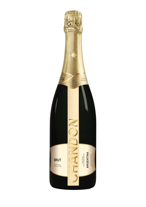 A bottle of CHANDON Brut sparkling wine from Argentina, with a gold and white label, next to an elegant wine glass filled with clear, sparkling white wine, arranged against a modern, minimalist background of an abstract, textured gold panel.